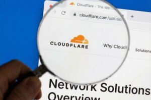 Magnifying glass highlighting the Cloudflare website during analysis of the November 18, 2025 outage caused by a misconfigured bot feature file that triggered global 5xx errors