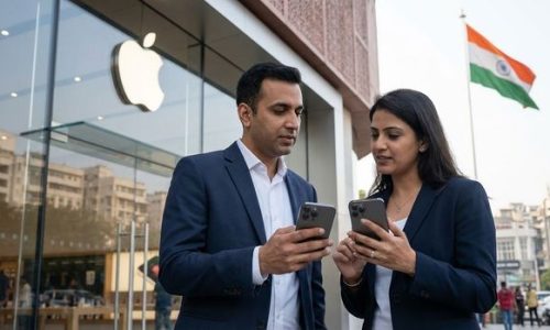 Two professionals standing outside an Apple Store in India reviewing their smartphones, illustrating the debate over the government’s attempted mandate for a non-removable cyber safety app on all devices